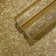 gold glitter wallpaper that is very shiny