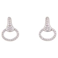 The Hermes Diamond 18k White Gold Horsebit Stud Earrings are a stunning blend of classic equestrian motifs and luxurious elegance, showcasing the brand's dedication to exceptional craftsmanship and sophisticated design. Crafted from exquisite 18k white gold, these earrings offer a radiant shine and enduring quality. The white gold's cool, polished finish provides a contemporary backdrop that enhances the overall allure of the earrings, making them a versatile addition to any jewelry collection. Hermes Earrings, Vintage Stud Earrings, Cross Earrings Studs, White Gold Earrings Studs, White Gold Studs, Earrings Making, Modernist Jewelry, Vintage Hermes, Halo Earrings Studs