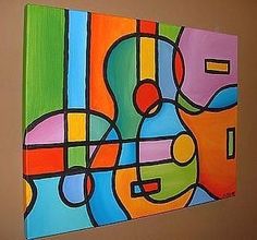 an abstract painting is hanging on the wall