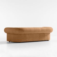 a couch that is sitting on top of a white floor and it's upholstered