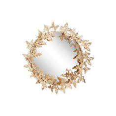 a round mirror with gold leaves on it