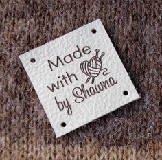 a label that says made with yarn by shanna on the side of a sweater