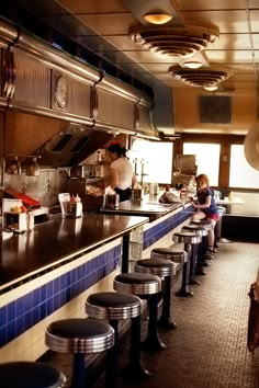 people are sitting at the counter in a restaurant