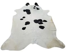 a cowhide rug with black spots on it