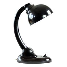 a black desk lamp on a white background