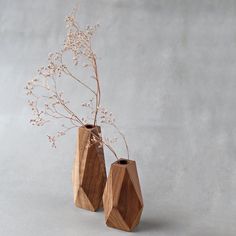 two wooden vases with flowers in them