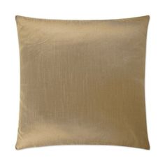 a gold pillow with pleated edges on a white background