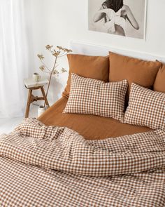 a bed covered in brown and white checkered sheets