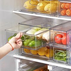 a refrigerator door is open with several bins full of vegetables and fruits in it