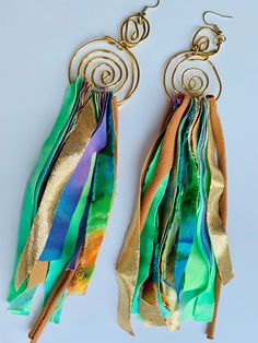 These hand crafted multi-color fabric earrings were inspired by and created for artistic women who value unique and creative self-expression - Each earring is crafted with 16 gauge premium copper gold wire into 2 golden swirls and multi-colored, cotton, knit, polyester, silk and rayon shredded fabric pieces are woven through the bottom - Each type of fabric is carefully selected with artistic eyes to compliment and bring out the radiant color dynamic and pattern of the unique fabrics -  We accep Silk Earrings, Artsy Green Earrings For Party, Green Artsy Earrings For Party, Artsy Green Earrings For Festival, Bohemian Green Wrap Earrings, Handmade Bohemian Multicolor Wrap Earrings, Artistic Green Earrings For Festival, Handmade Modern Multicolor Earrings, Hippie Multicolor Handmade Earrings