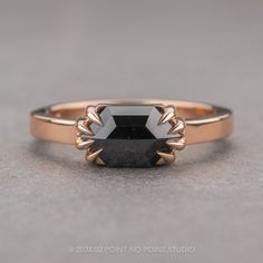 a black diamond ring sitting on top of a table