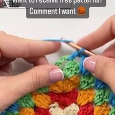 two hands are crocheting together to make a colorful granny's flower motif