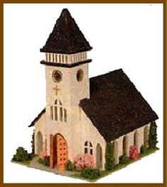 a paper model of a church with a brown roof and steeple on the top