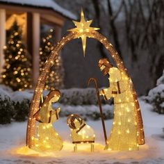 lighted nativity scene in front of a house