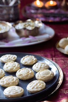 some cookies are sitting on a black plate