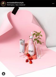 a pink background with strawberries and other items