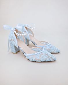 "Crochet Lace Wedding Shoes Collection. Classic and refined almond toe crochet lace with added pearls strap details. Choose from pearl/gold, pearl/silver, or all pearls ankle straps to match with your bridal look. The luminous pearls makes this a classy and elegant shoes for wedding, evening wear, or romantic date. DETAILS: HEEL HEIGHT: 2.75 inches COLORS AVAILABLE: Ivory, White and Light Blue UPPER: Synthetic upper and lining MATERIALS: Manmade outsole STYLE NAME: ABBY  SIZE FIT: RUNS LARGE  No Spring Wedding Lace Shoes, Spring Wedding Shoes With Lace And Ankle Strap, Lace Wedding Shoes With Lace Trim And Round Toe, Lace Wedding Shoes With Round Toe And Lace Trim, Spring Wedding Shoes With Ankle Strap In Lace, Summer Lace Wedding Shoes With Low Heel, Light Blue Ankle Strap Wedding Shoes, Lace-up Lace Heels For Ceremony, Evening Lace Wedding Shoes With Ankle Strap