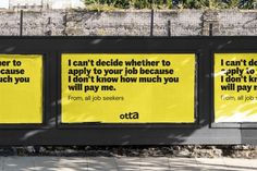 three billboards on the side of a building with words written in black and yellow