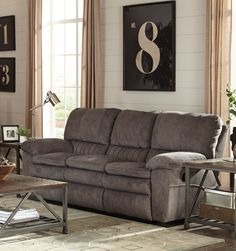 a living room with two couches and a coffee table in front of the window