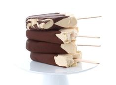 four ice cream bars stacked on top of each other with toothpicks sticking out of them