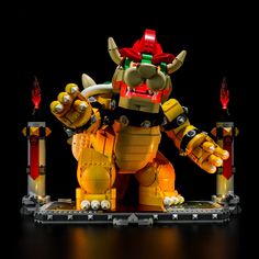 a lego model of a giant yellow monster with two arms and legs, standing in front of a black background