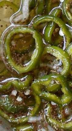 green peppers are being cooked in oil and seasoning on the stove top burner