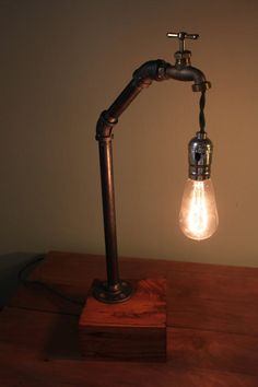 a lamp that is sitting on top of a wooden table next to a light bulb