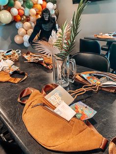 the table is set with an orange purse and several other items on top of it