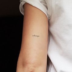 a woman's arm with the word hope tattooed on her left arm, in black ink