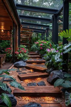 an outdoor walkway with stepping stones and plants on the sides, surrounded by greenery