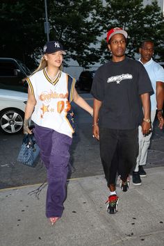 a man and woman walking down the street