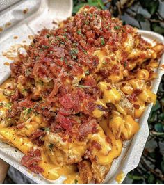 a tray filled with pasta covered in sauce and toppings