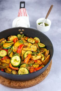 a pan filled with cooked vegetables on top of a table