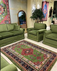 a living room filled with green couches and rugs