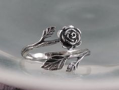 "This sterling silver rose ring is beautifully sculptural. It's oxidized to show the graceful flow of each petal. The rose is considered the \"Queen of all Flowers\"  and has been cultivated for thousands of years for its magnificent beauty and scent. A wonderful gift of love, or for one who loves the beauty of nature. This ring, as shown, is a size 7 and is fully adjustable. If you have a specific size in mind, please leave a note and I will re-size it for you." Silver Rose Detail Sterling Silver Jewelry, Sterling Silver Rose Flower Jewelry, Silver Rose Design Jewelry For Promise Ring, Silver Rose Ring Jewelry, Adjustable Rose Sterling Silver Jewelry, Adjustable Sterling Silver Jewelry In Rose Color, Sterling Silver Rose Design Flower Ring, Sterling Silver Rose Flower Ring With Rose Design, Adjustable Sterling Silver Flower Ring With Rose Design