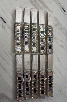 several silver and multicolored pieces of luggage sitting on top of a marble surface