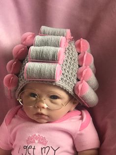 a baby wearing a knitted hat and glasses