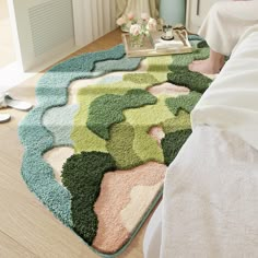 a bedroom with a bed and rugs on the floor