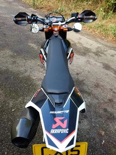 the back end of a motorcycle parked on top of a road