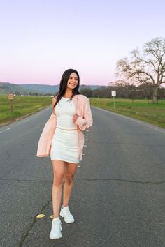 woman walking in the middle of the road street, street photoshoot, road photoshoot, pink and purple sunset, pink button down, oversized button down outfit, how to style women's button down, oversized button up women's outfit, pink button up, white set outfit, how to style white set, upper bidwell park, chico california, butte county, lifestyle model, chasing sunsets, sunset park photoshoot Our Happy Place, We Are All Human, White Flag, Professional Look, Woven Cotton, Pet Hair, Pale Pink, Cotton Weaving, Woven Fabric