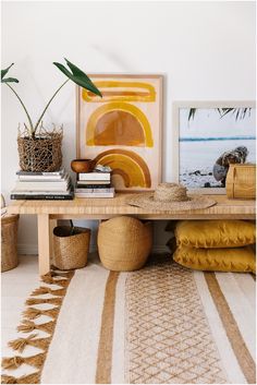 a table with some plants on top of it next to pictures and other items in baskets