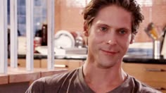 a man standing in front of a kitchen counter