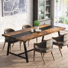 a dining room table with chairs and a potted plant on the table in front of it