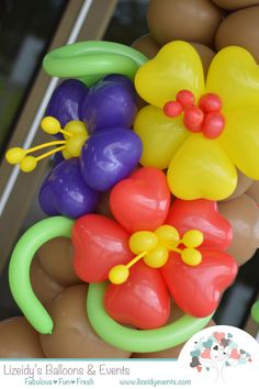 a bunch of balloons that are in the shape of flowers