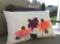 a pillow with three flowers painted on it