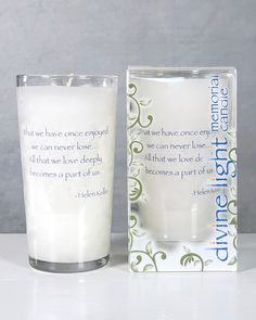 an empty glass next to a boxed candle