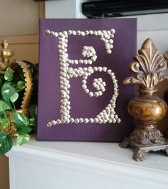 a purple and white sign sitting on top of a mantle