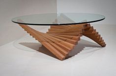 a glass and wood coffee table with an unusual design