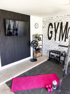 there is a gym room with pink mats on the floor