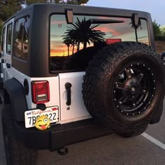 a white jeep parked in a parking lot